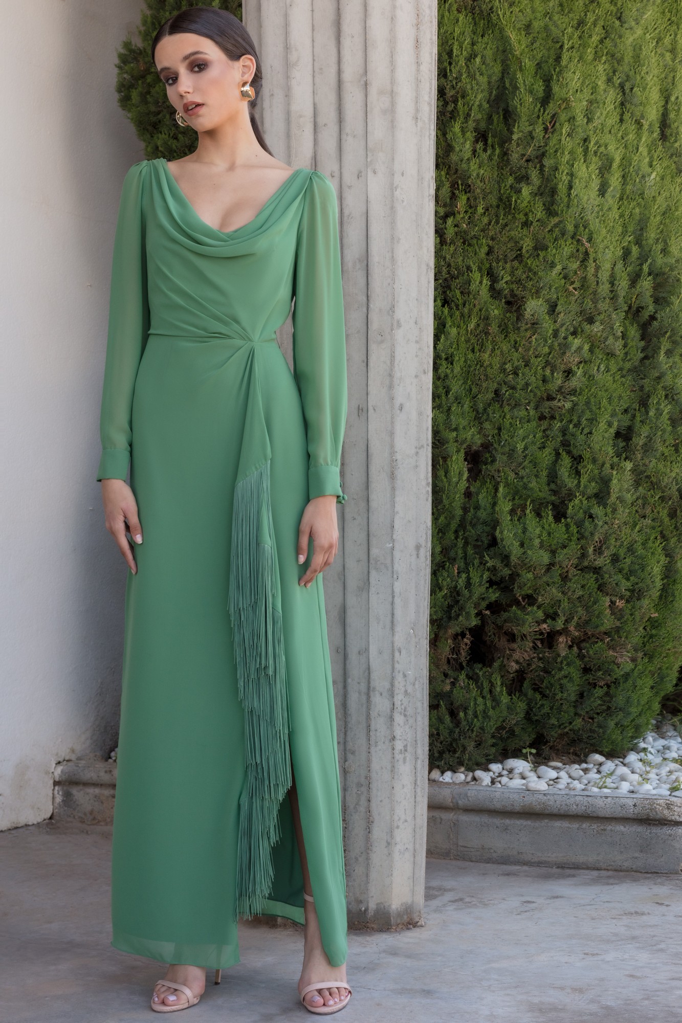 Long dress made in green chiffon, original cascade neckline and fringe detail in skirt.